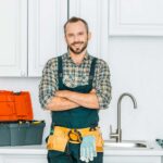 Plumber in kitchen