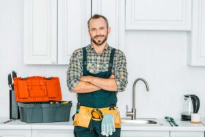 Plumber in kitchen